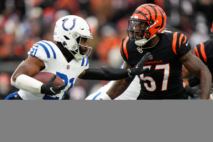 Dec. 10, 2023; Cincinnat, Ohio, USA; Indianapolis Colts running back Zack Moss (21) carries the ball as Cincinnati Bengals linebacker Germaine Pratt (57) defends in the first quarterat Paycor Stadium.